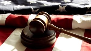 stock-footage-gavel-and-american-flag-gavel-strikes-wooden-base